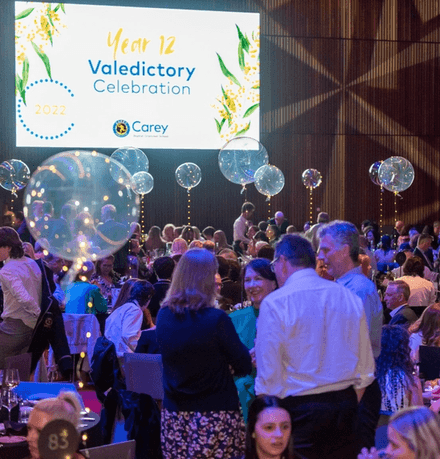Parents and students at the Year 12 Valedictory Celebration with floating balloons and fairylights attached to gala tables